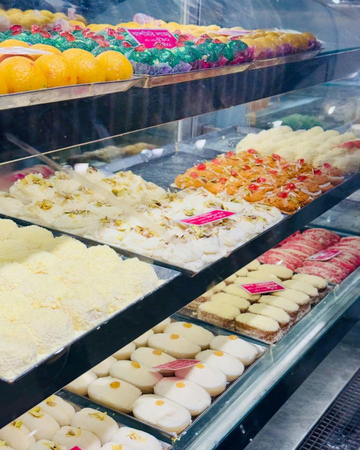 Sweet shop counter full of colourful Indian mithai